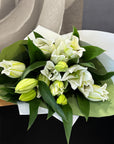 Bouquet of white Oriental Lillies and foliage, gift wrapped.
