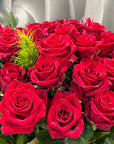 Bouquet of 24 red roses with foliage