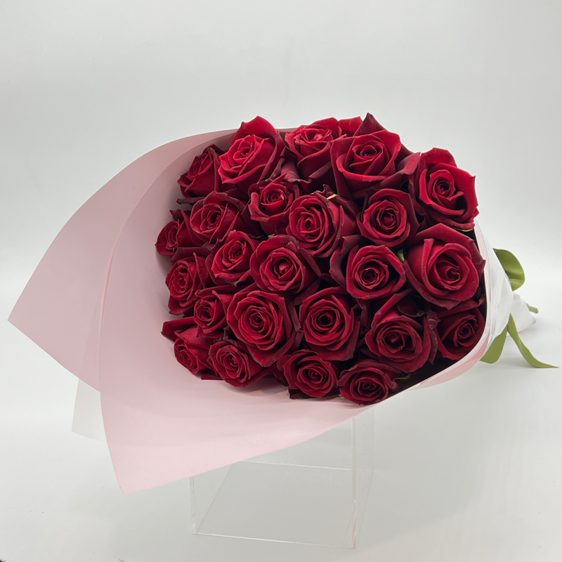 A bouquet of 24 premium red roses with long stems, elegantly wrapped.