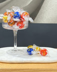 Lindt Lindor Chocolate balls on a white marble plate on a wooden bench.