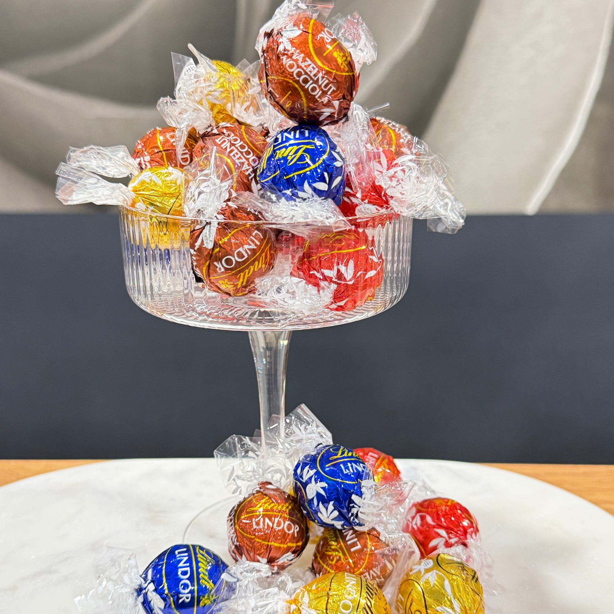 Lindt Lindor Chocolate Balls in a coupe glass in front of a blurred back ground 