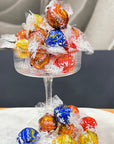 Lindt Lindor Chocolate Balls in a coupe glass in front of a blurred back ground 