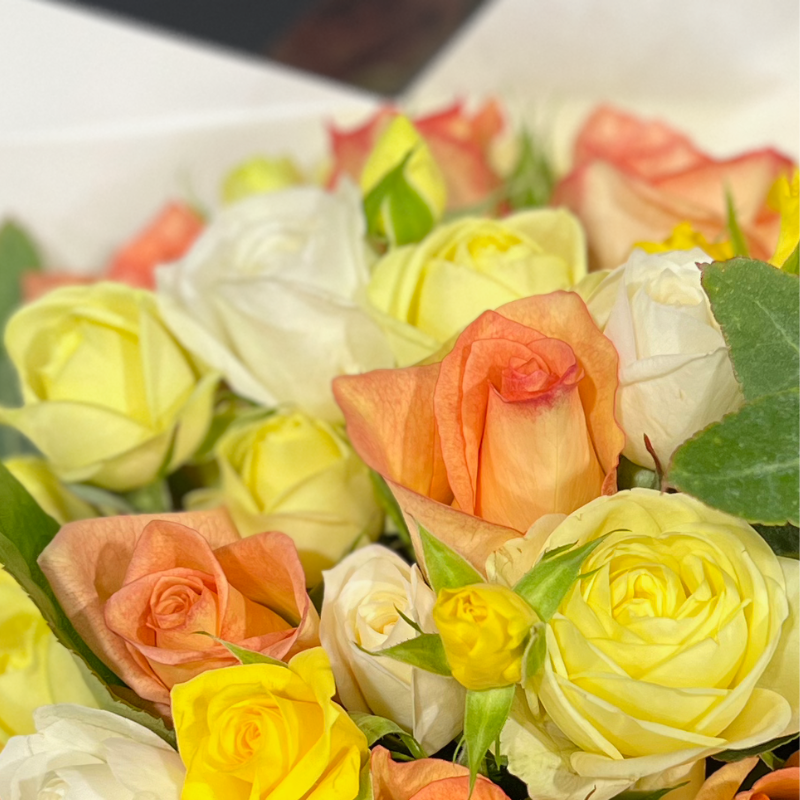 Close up image of posy of Lemon and pale orange roses