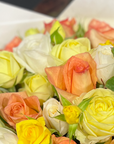 Close up image of posy of Lemon and pale orange roses
